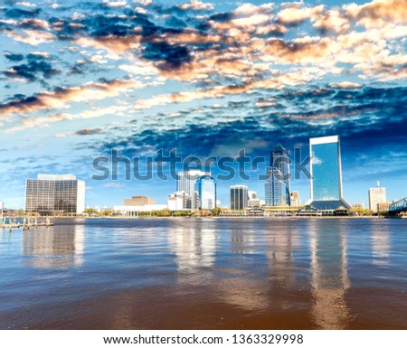 Downtown Jacksonville and St Johns River from Southbank Riverwalk. Beautiful water reflections on a sunny day.