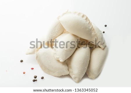 heap of frozen dumplings on a white background. Isolated Dumplings Royalty-Free Stock Photo #1363345052