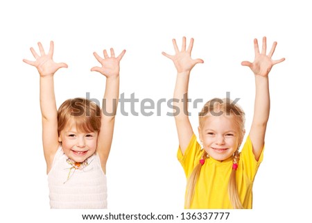 Two little girls raising their hands up. Young students or helpers. Isolated on white background