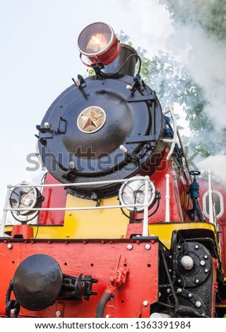 Old soviet steam locomotive blowing off the steam out of the whistle