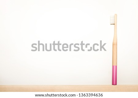 pink bamboo toothbrushes on white background.
Place for text. Ecoproduct.   eco-friendly.