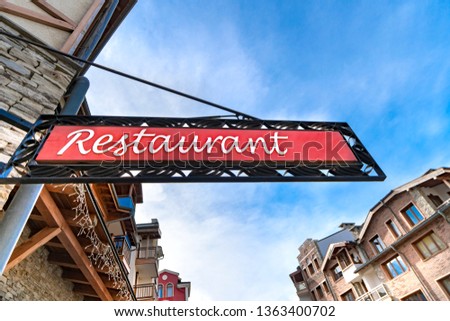 Vintage art deco neon restaurant sign on a city street storefront