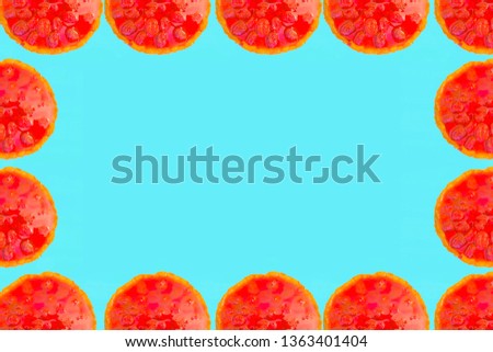 Red cake with strawberries on a turquoise background. Frame for picture of pies. 