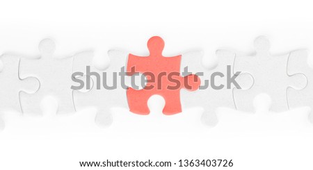 White jigsaw puzzle pieces row with red one isolated on white, clipping path included