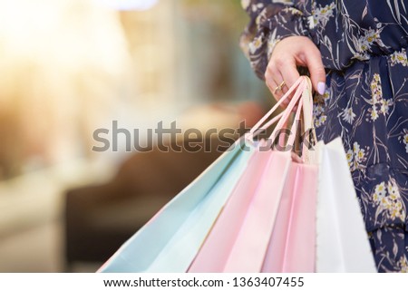 Happy woman shopping for clothes in store