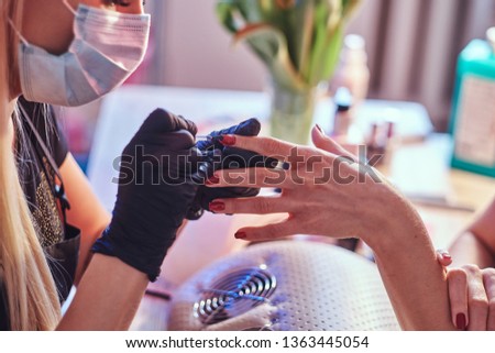Closeup hands. Nail care and manicure. Woman in a beauty salon 
