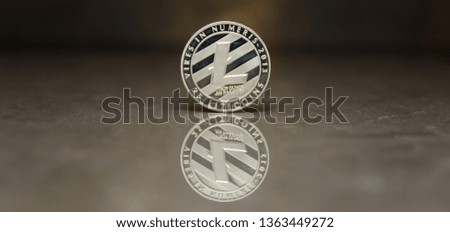 Silver Litecoin on reflective surface