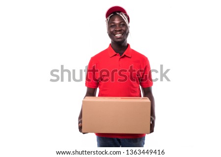 Portrait of Happy African American delivery man in red cloth holding a box package isolated on white Background.