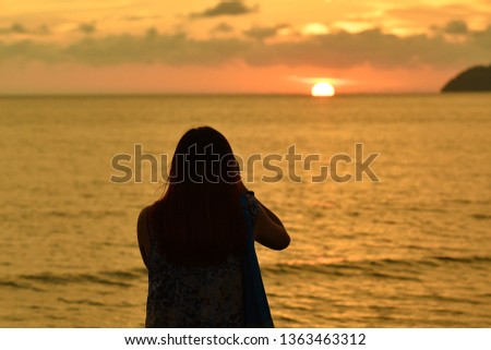 Silhouettes of people taking photo in Tanjung Aru Beach, Kota Kinabalu, Sabah Borneo, Malaysia. 