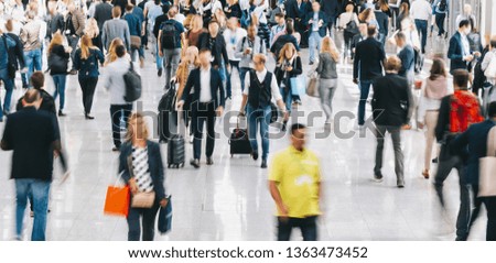 unrecognizable business people rushing in a modern trade fair hall 