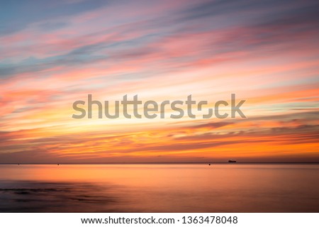 Sunrise over a beach in Cornwall UK Royalty-Free Stock Photo #1363478048
