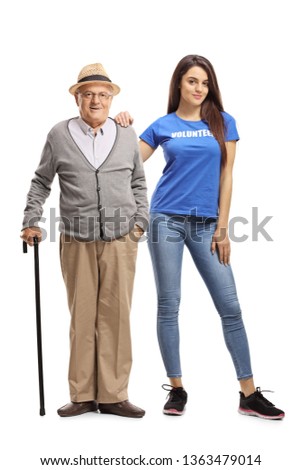 Full length portrait of a senior man with a cane and a young woman volunteer posing isolated on white background