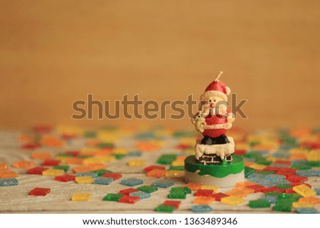 Santa Cross doll candle on colorful mosaic floor selective focus and shallow depth of field