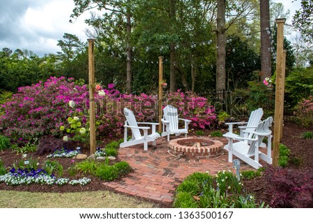 Welcome Spring and Summer with gardens designed for entertaining. Landscaped home design, small fairy gardens, painters get inspiration among the flowers. Royalty-Free Stock Photo #1363500167