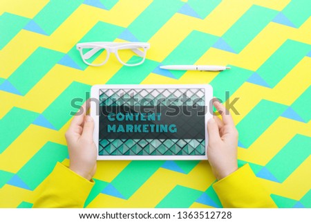 Man holds a tablet and looks at the screen. Mobile development. Innovational online businesses. Internet technologies. Trendy design. Geometry. Fashionable vibrant colors. Using a device. UX and UI.