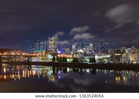 Night panorama of Portland, Oregon. Reflections of city lights in Willamette river
