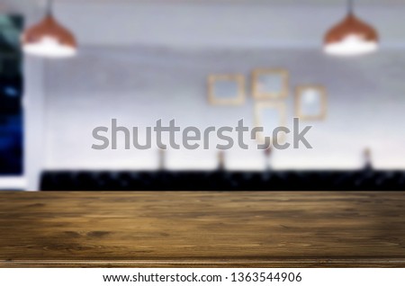 Wooden table on abstract blurred interior restaurant background and free space for decoration display or montage products.