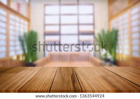 Wooden table on abstract blurred interior background and free space for your decoration display or montage your products.
