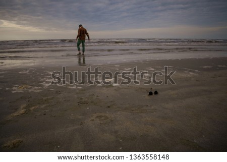 Trendy Model On The Beach Walking Into The Water Fully Clothed 
