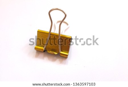 Top view and close up yellow metal clip on white background