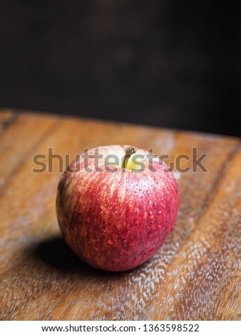 Close up red apple on wooden table.