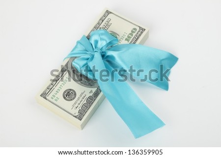 Pack of dollars in a blue ribbon on white background