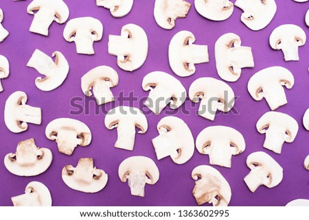 Sliced mushrooms on purple background. Top view