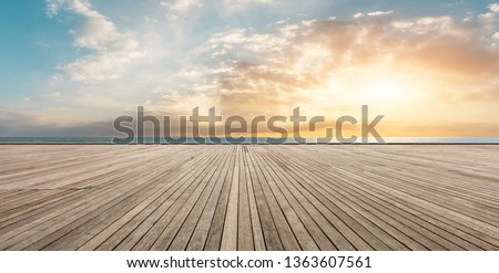 Wooden floor platform and blue sea with sky background Royalty-Free Stock Photo #1363607561