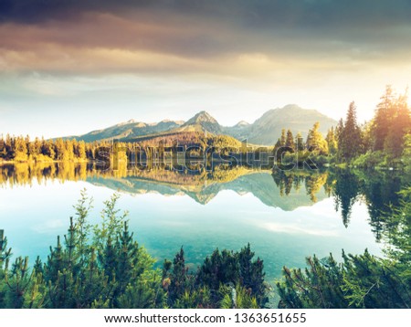 Calm lake in National Park High Tatra. Location place Strbske pleso, Slovakia, Europe. Photo toned style instagram filters, vintage effect. Scenic image of popular travel destination. Beauty of earth.