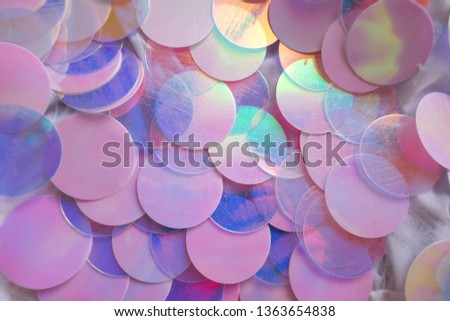 Sequins macro background.large sequins in blue and pink colors.Fabric with sequins in pastel tone.ridescent fabric.Scales background. Blue Background with shiny sequin