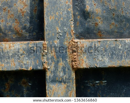Dark blue iron plate rusty due to exposure to the weather
