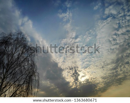 Photo of a beautiful sunset sky with voluminous cirrus clouds on a spring day