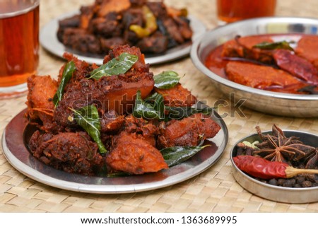Hot drinks and Chicken 65 hot and spicy  chicken fry, fish curry, beef roast in Kerala, South India. Non vegetarian starter or quick snack. A popular deep fried dish in a coating of Indian spices. 
