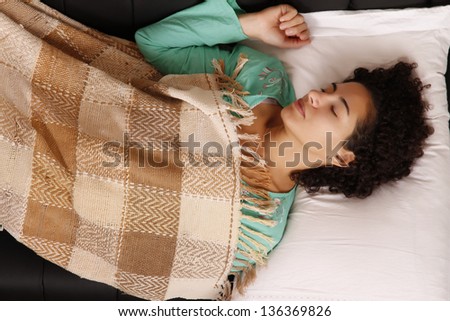 A jung brazilian woman relaxing on the sofa.