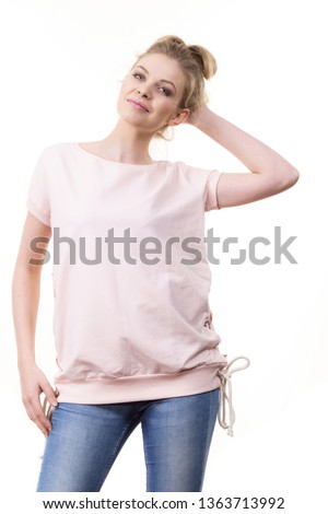 Adult woman presenting her casual beautiful outfit, short sleeved pink top and jeans.