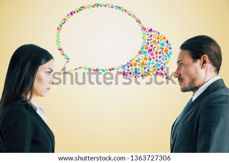 Attractive young european businessman and woman with creative colorful hand gesture speech bubble on yellow background. Social network and communication concept