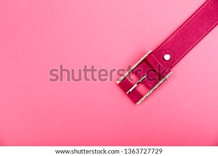 Pink women style belt isolated on rose background. 