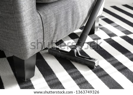 Hoovering of carpet with vacuum cleaner