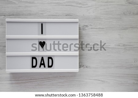 'I love dad' words on modern board over white wooden background, top view. Overhead, from above, flat lay. Copy space.