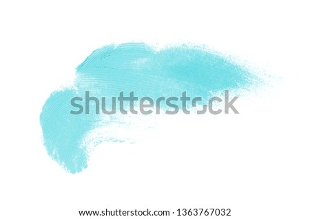 Smear and texture of lipstick or acrylic paint isolated on white background. Stroke of lipgloss or liquid nail polish swatch smudge sample. Element for beauty cosmetic design. Light blue color
