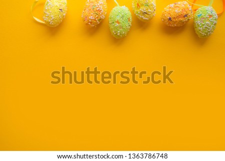 Colorful easter eggs on yellow background