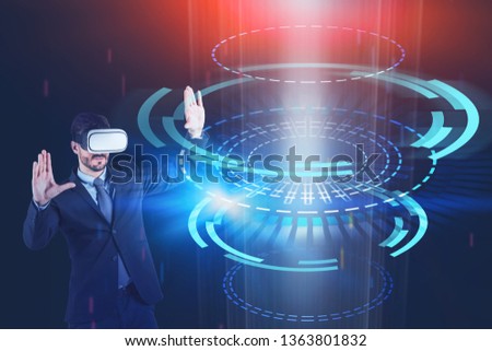 Young man in suit and VR headset working with immersive HUD interface. Concept of hi tech and system engineering. Toned image double exposure