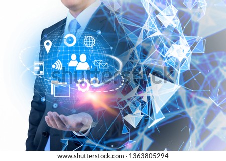 Unrecognizable businessman holding virtual internet icons holograms with double exposure of polygonal image. Concept of hi tech in business. Toned image
