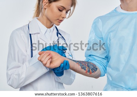 Woman doctor patient tattoo blue gloves stethoscope                               