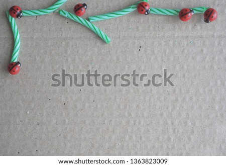 Paper surface background with colorful candles and pins.