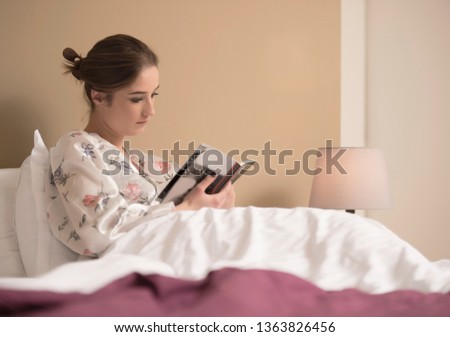 woman reading book in the bedroom. 