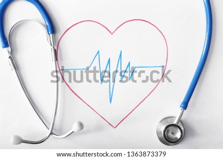 Stethoscope with cardiogram, closeup