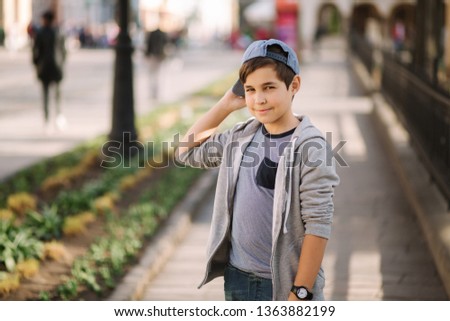 Teenage boy wears a cap. Stylish male outside