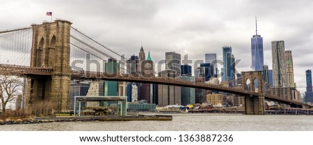 Panorama view of Brooklyn Bridge from Dumbo with New York skyscraper and cloudy background. Beautiful view in Midtown Manhattan, New York City, USA.