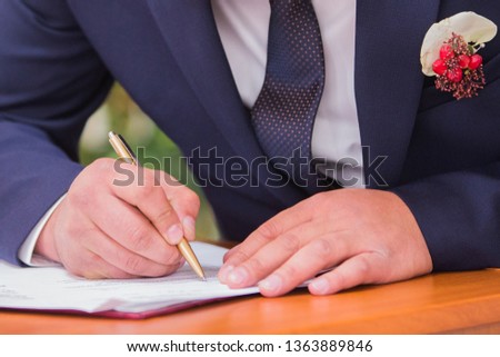 The newlyweds put their signature on the marriage documents at the Wedding Palace